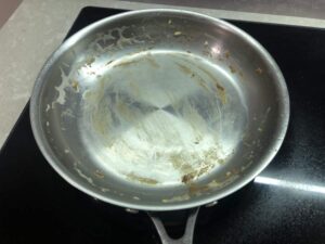 Burnt eggs on stainless steel pan