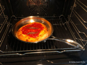 Cooking pizza in a stainless steel pan