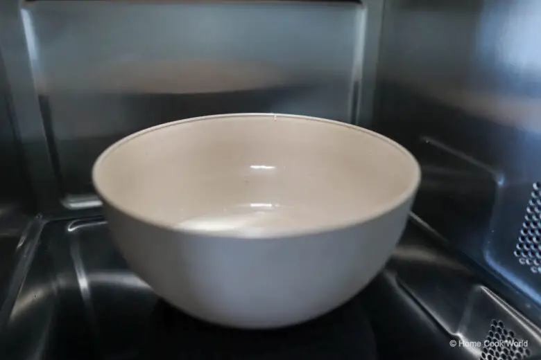Photo of a bowl of water inside a microwave oven.