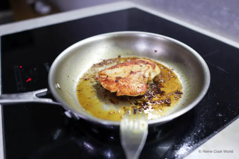 Pan-frying chicken in a stainless steel skillet