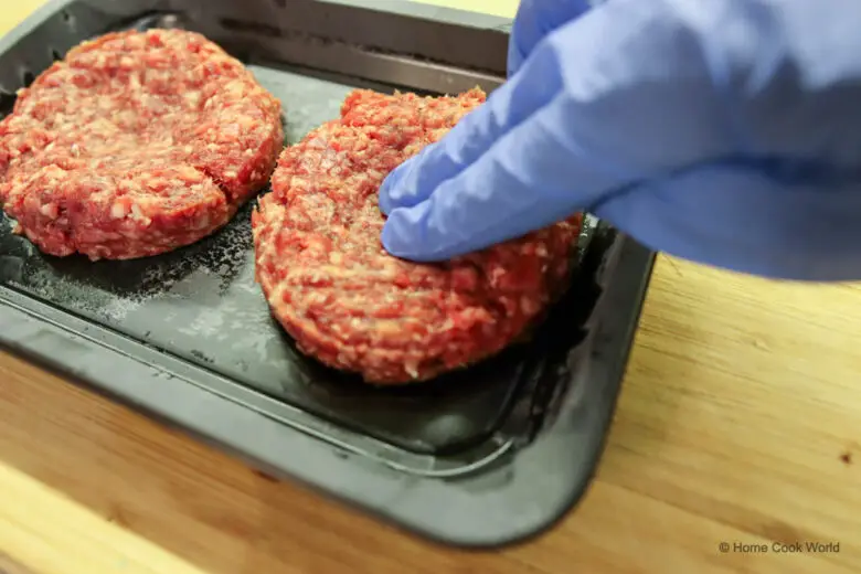 Making an indentation in a burger patty