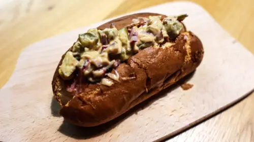Photo of a cheddar and mustard hot dog
